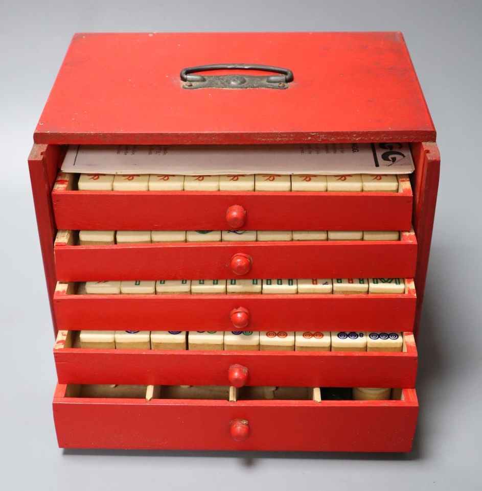 A Mah Jong set in red stained wood case